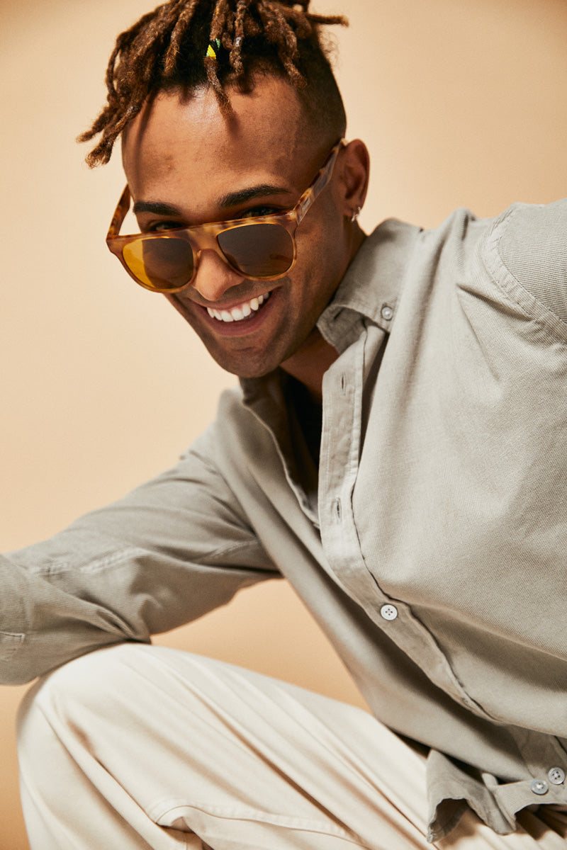 Male model wearing orange polarised sunglasses from Ozeano Vision