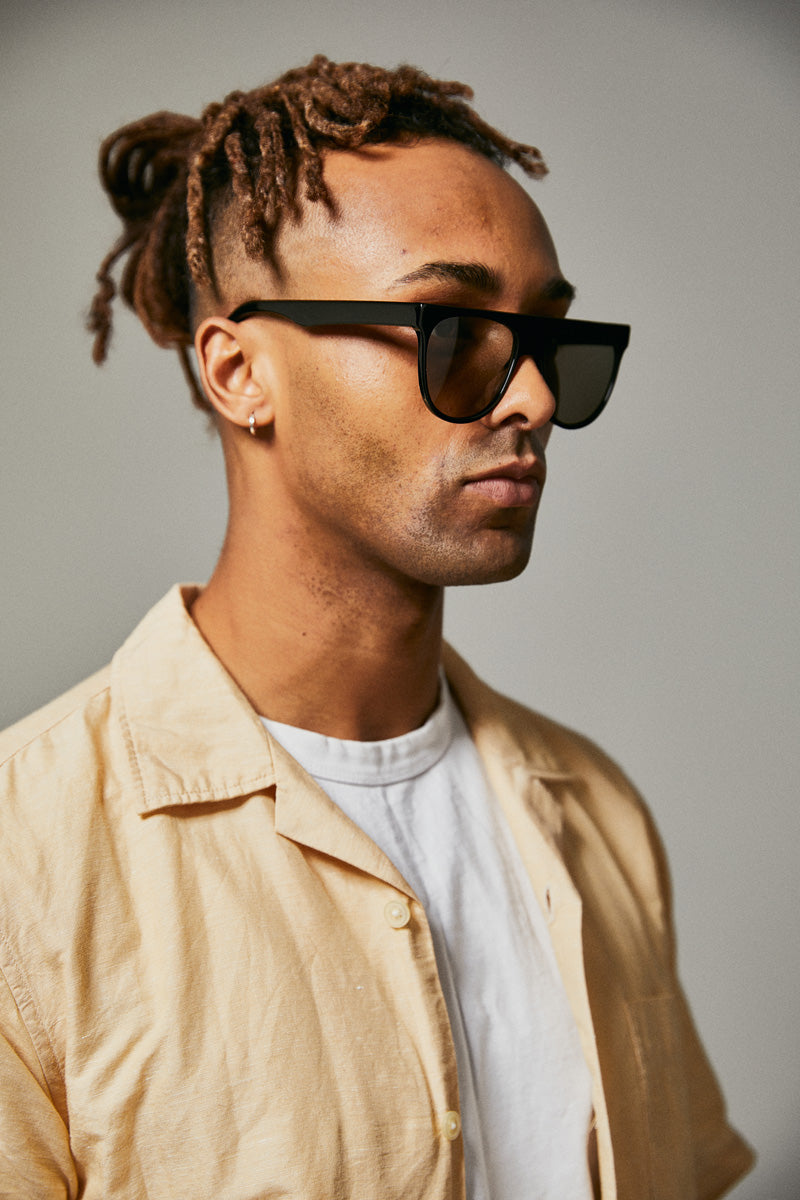 Male model wearing black polarised sunglasses from Ozeano Vision