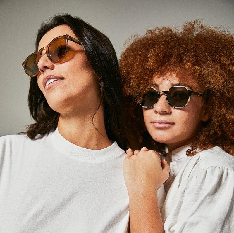 Female model wearing black and white polarised sunglasses from Ozeano 