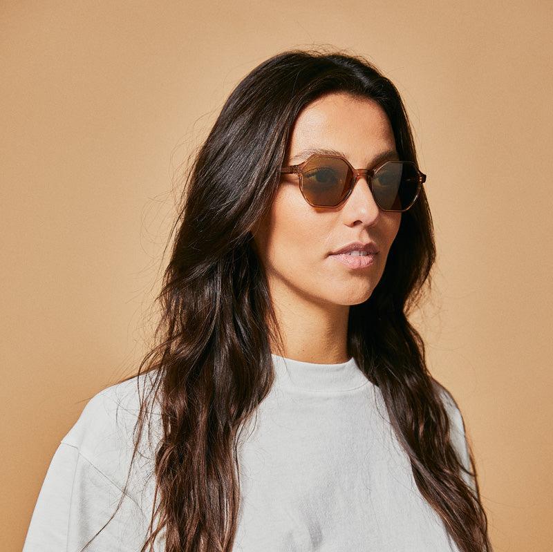 Female model wearing brown polarised sunglasses from Ozeano Vision