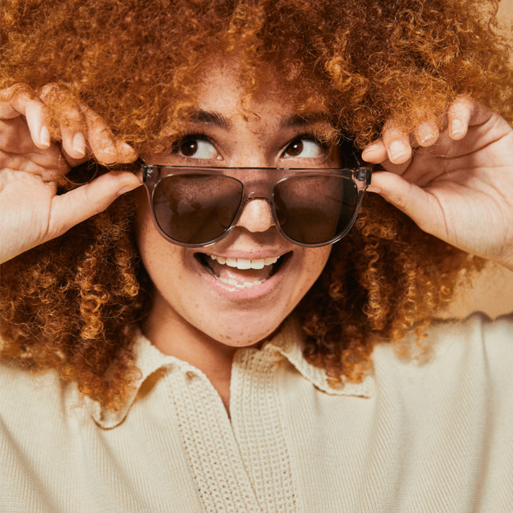 Female model wearing grey polarised sunglasses from Ozeano Vision