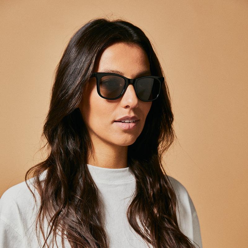 Female model wearing black polarised sunglasses from Ozeano Vision