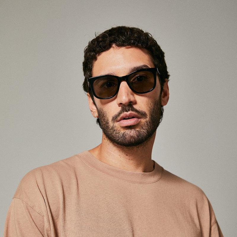 Male model wearing black polarised sunglasses from Ozeano Vision