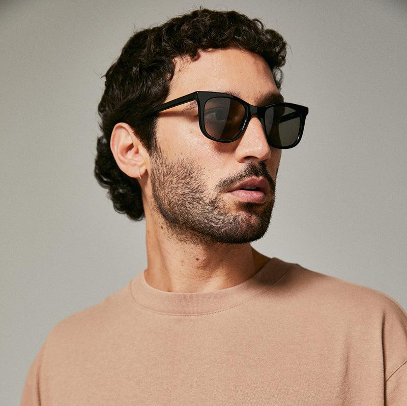 Male model wearing black polarised sunglasses from Ozeano Vision