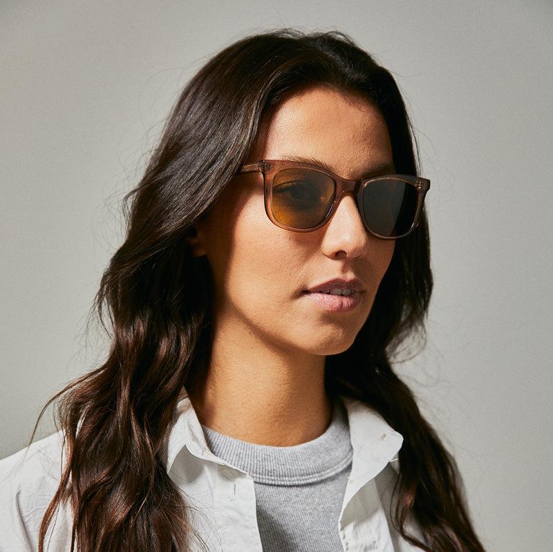 Female model wearing brown polarised sunglasses from Ozeano Vision