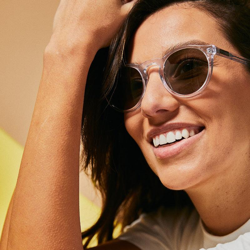 Female model wearing translucent polarised sunglasses