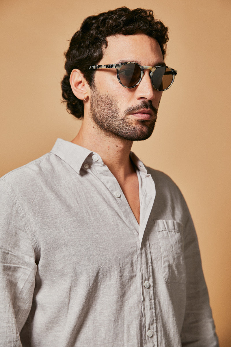 Male model wearing black and white polarised sunglasses