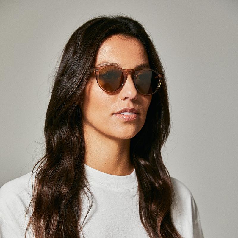 Female model wearing brown polarised sunglasses