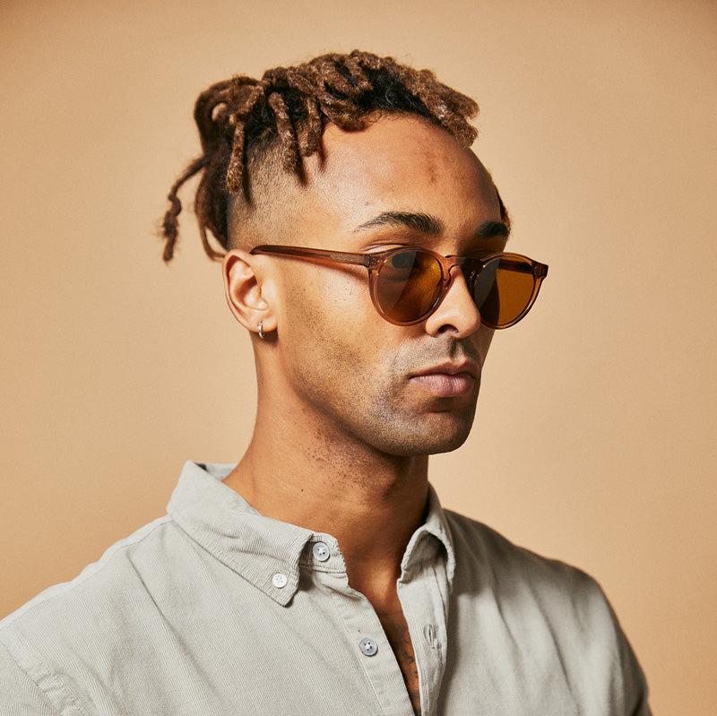 Male model wearing brown polarised sunglasses